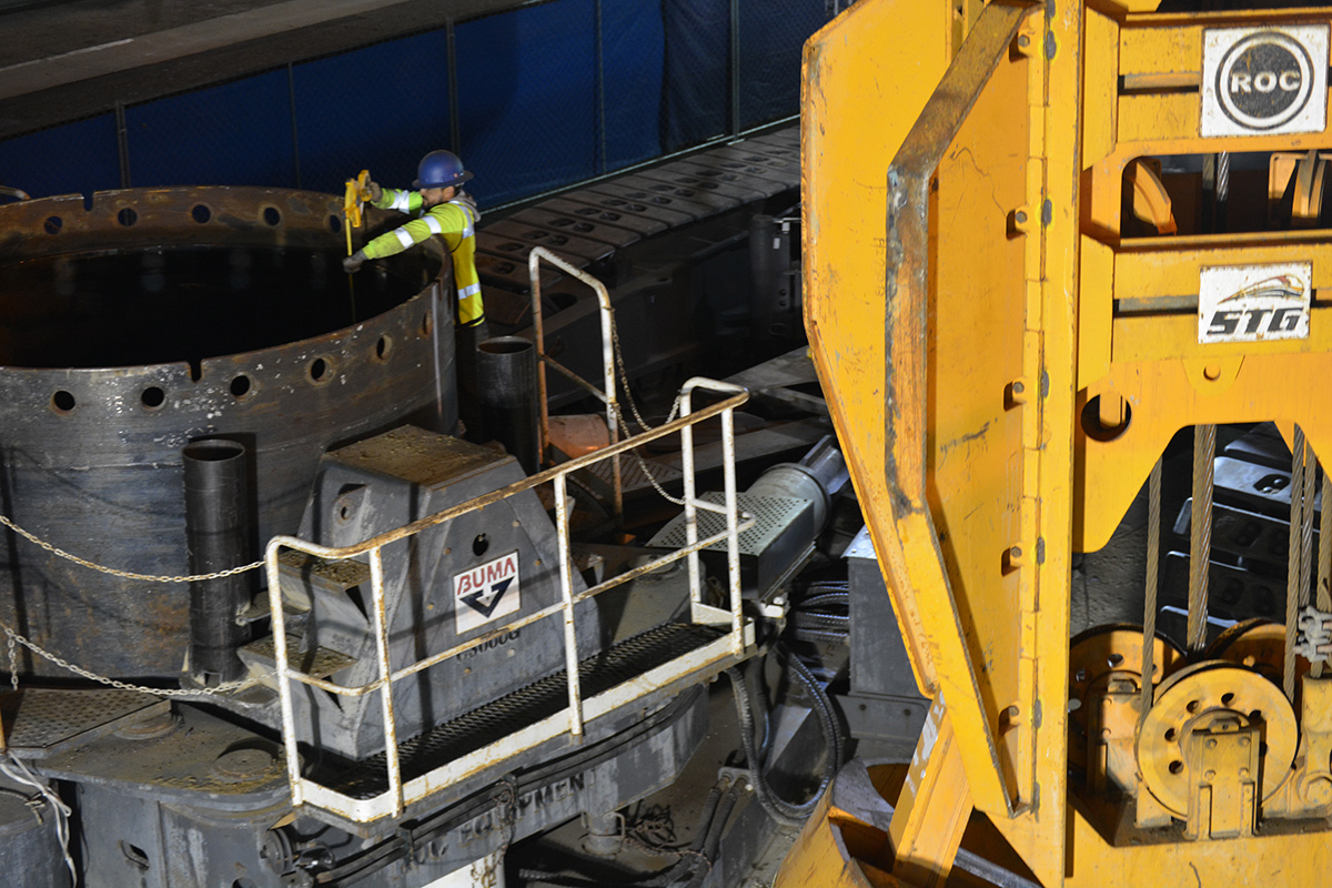 crew member measures the depth of the first cast-in-drilled-hole pile 