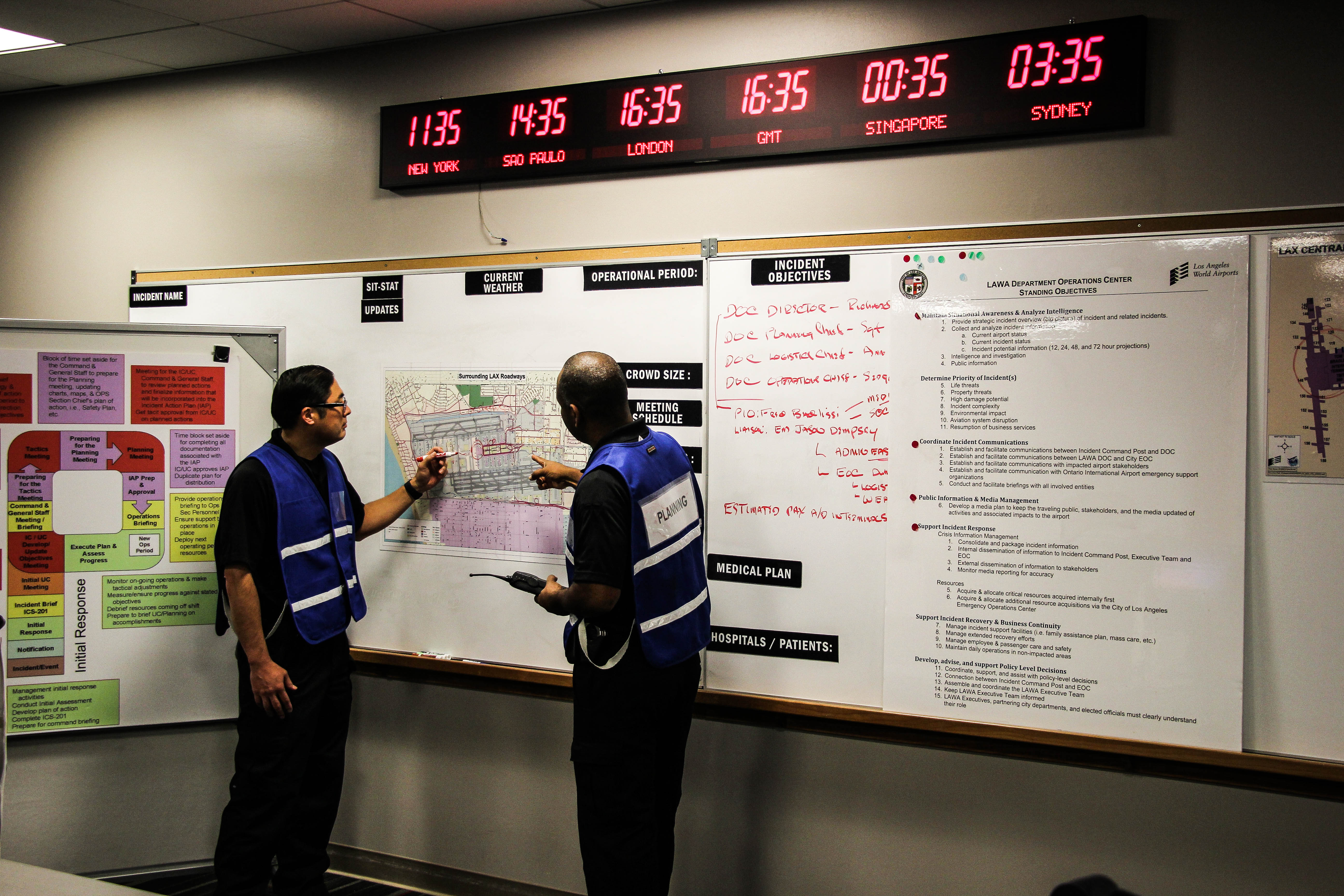 ARCC Office - Two ARCC officers discuss over airport map