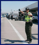 Officer providing sign direction to motorist